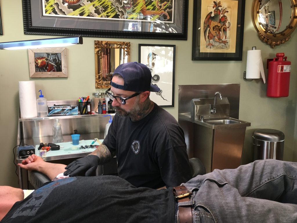 Owner Jeff Johnson of Dire Wolf Tattoo and Fine Art. Their shop was packed during an all-day benefit for shooting victims' families. CREDIT: Ina Jaffe/NPR