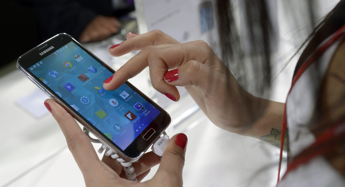 A Samsung Galaxy S5 is demonstrated at the Mobile World Congress, the world's largest mobile phone trade show in Barcelona, Spain. CREDIT: FERNANDEZ/AP