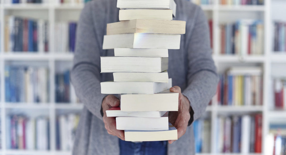 Balancing stack of books. Photo by Getty Images