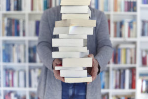 Balancing stack of books. Photo by Getty Images