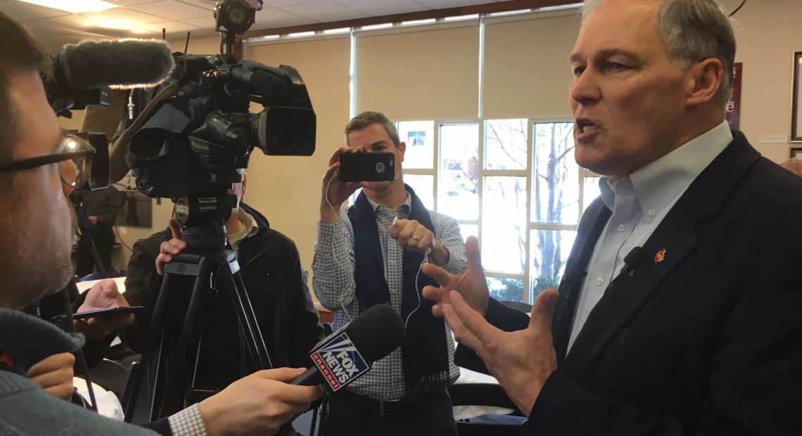 Gov. Jay Inslee speaks with reporters following a talk on climate change at the New Hampshire Institute of Politics in Manchester, Jan. 22, 2019. CREDIT: AUSTIN JENKINS/N3