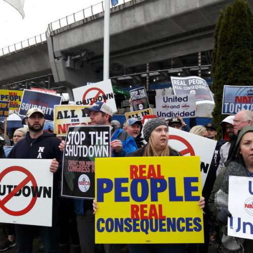 TSA screeners and air traffic controllers called for an end to the partial government shutdown during a rally outside Seattle-Tacoma International Airport on Tuesday. CREDIT: CASEY MARTIN / KUOW