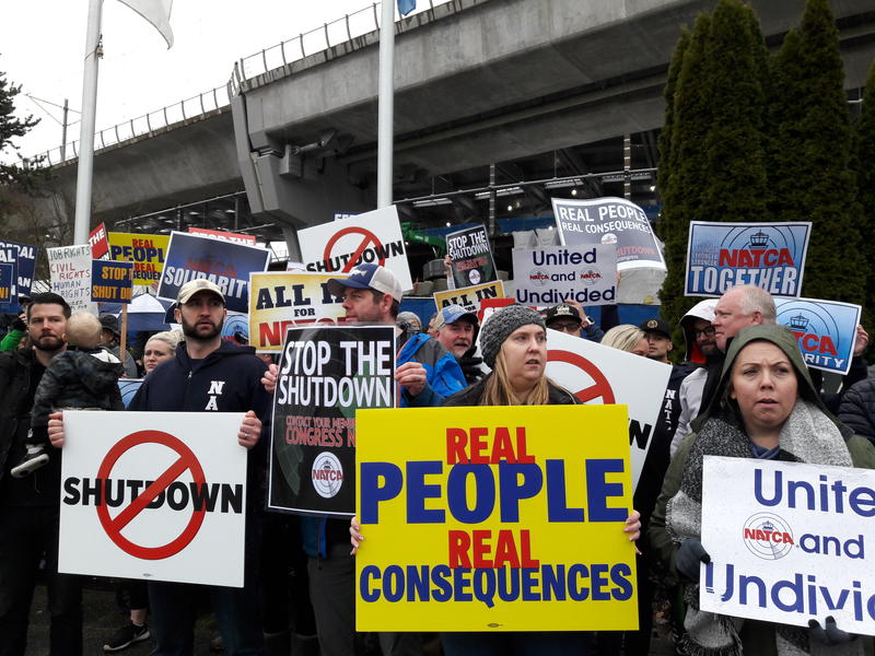 TSA screeners and air traffic controllers called for an end to the partial government shutdown during a rally outside Seattle-Tacoma International Airport on Tuesday. CREDIT: CASEY MARTIN / KUOW