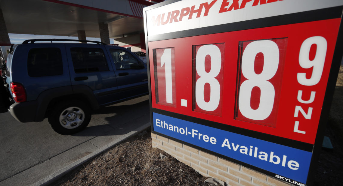 Motorists drive past a sign advertising regular gasoline at $1.88 per gallon at a station in Longmont, Colo., on Dec. 22, 2018. Falling gasoline prices have given drivers a little extra cheer this winter. CREDIT: David Zalubowski/AP