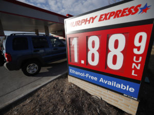 Motorists drive past a sign advertising regular gasoline at $1.88 per gallon at a station in Longmont, Colo., on Dec. 22, 2018. Falling gasoline prices have given drivers a little extra cheer this winter. CREDIT: David Zalubowski/AP