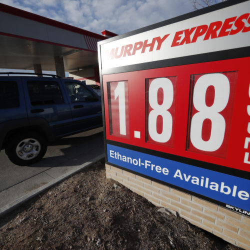 Motorists drive past a sign advertising regular gasoline at $1.88 per gallon at a station in Longmont, Colo., on Dec. 22, 2018. Falling gasoline prices have given drivers a little extra cheer this winter. CREDIT: David Zalubowski/AP