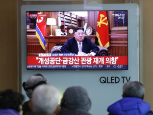 People watch a TV news on a screen showing North Korean leader Kim Jong Un delivering his New Year's speech, at Seoul Railway Station in Seoul, South Korea, on Tuesday. Ahn Young-joon/AP