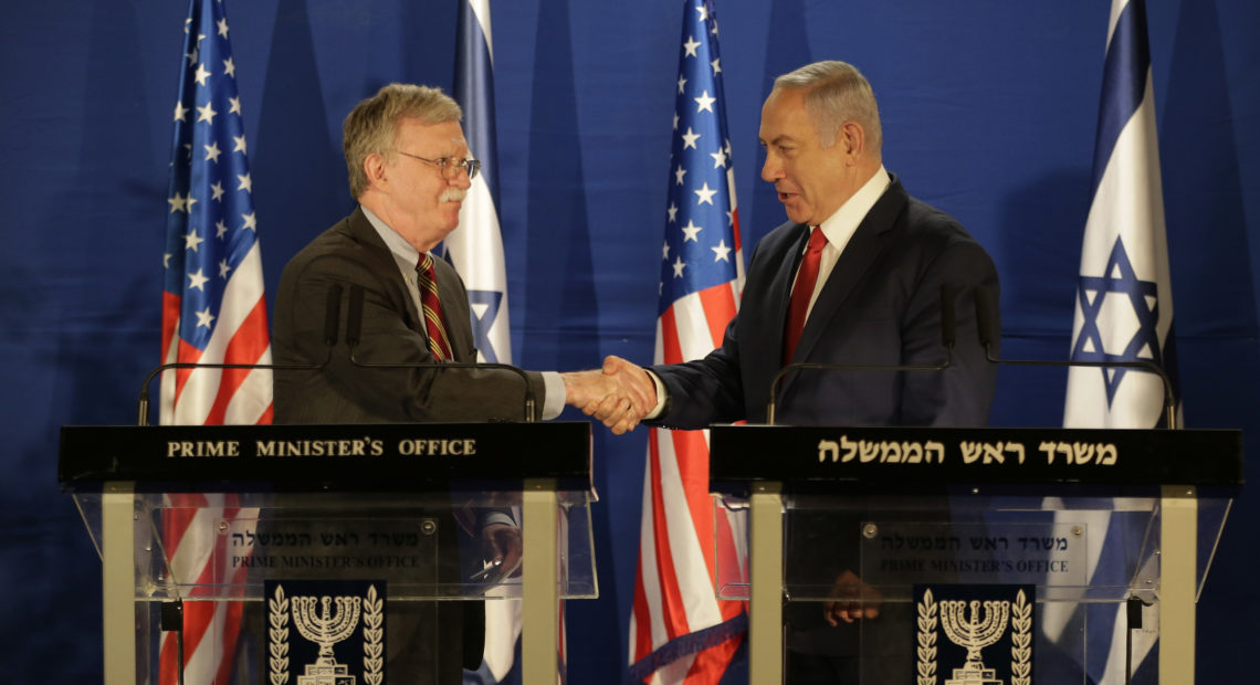 U.S. National Security Adviser John Bolton (left) and Israeli Prime Minister Benjamin Netanyahu shake hands during a joint statement to the media follow their meeting, in Jerusalem on Sunday. CREDIT: Oded Balilty/AP
