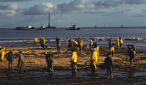 Cleanup workers rake oil-soaked hay along a Santa Barbara beach in 1969, after an oil spill that was then the largest in U.S. history. CREDIT: BETTMANN/GETTY IMAGES
