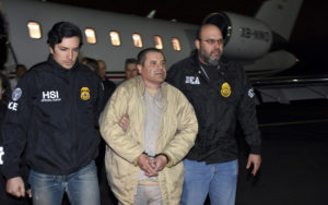 U.S. law enforcement personnel escort Joaquín "El Chapo" Guzmán from a plane to a waiting caravan of SUVs at New York's Long Island MacArthur Airport in January 2017. U.S. law enforcement via AP