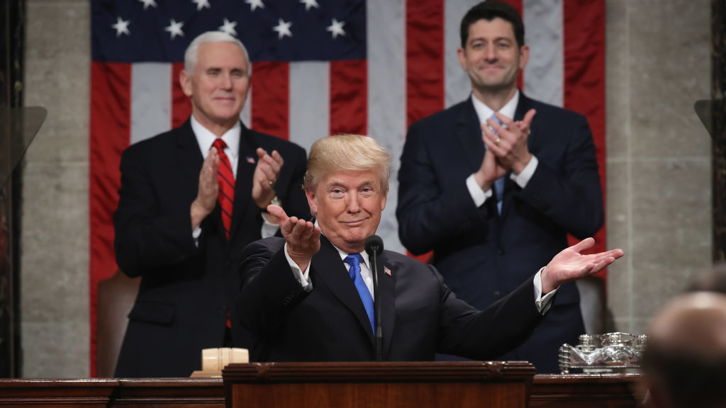President Trump delivers the State of the Union address in January 2018 as Vice President Pence and then-Speaker of the House Paul Ryan look on in the chamber of the House of Representatives. CREDIT: Win McNamee/AFP/Getty Images