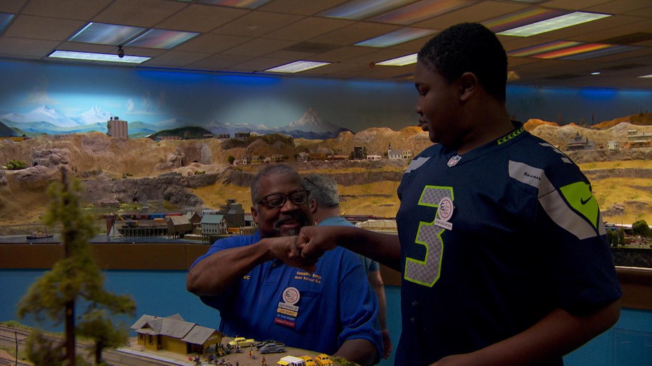 Rewiring the lights of Hood River earns Demarion Brown a fist bump from his grandfather, Isaac Harpole, Jr. CREDIT: NICK FISHER/OPB