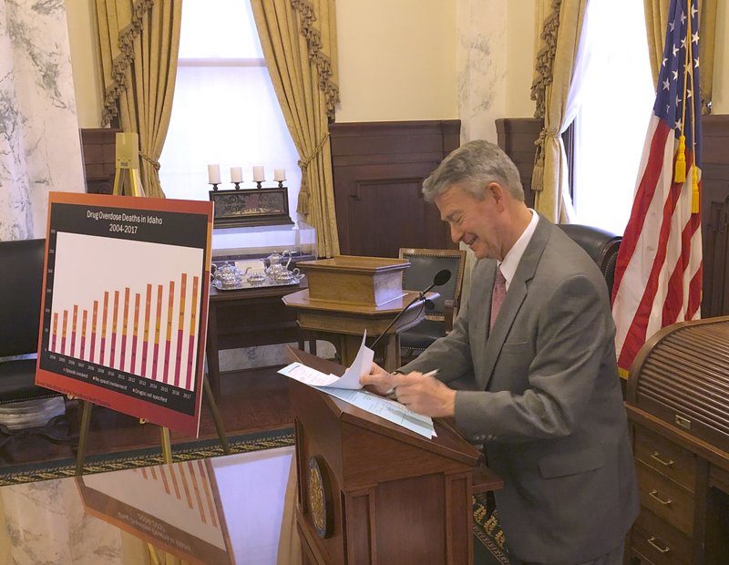 Idaho Gov. Brad Little signs into law legislation to make the overdose reversal drug naloxone more readily available. CREDIT: Keith Riddler/AP News