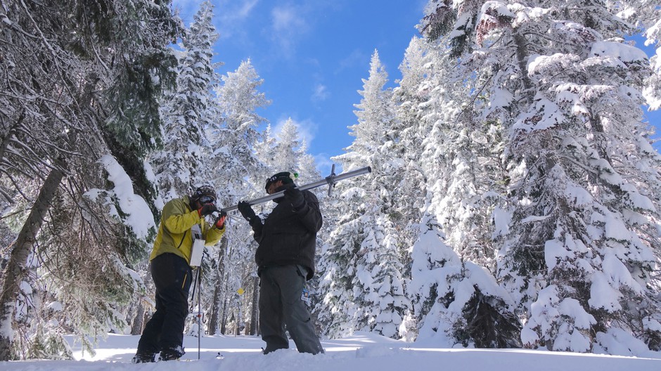 Ben Thorpe (left) and Shavon Haynes measure the snowpack on Mount Ashland. CREDIT: JES BURNS/OPB