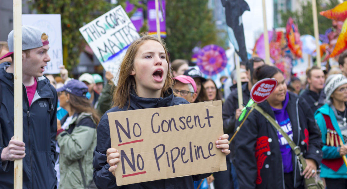 A protester holds a sign stating during a Kinder Morgan (Trans Mountain) Pipeline rally on Sept. 9, 2017 in Vancouver, Canada. CREDIT: WILLIAM CHEN/WIKIMEDIA/CREATIVE COMMONS