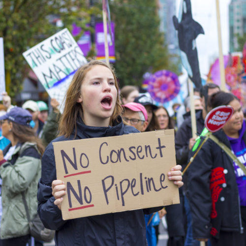 A protester holds a sign stating during a Kinder Morgan (Trans Mountain) Pipeline rally on Sept. 9, 2017 in Vancouver, Canada. CREDIT: WILLIAM CHEN/WIKIMEDIA/CREATIVE COMMONS