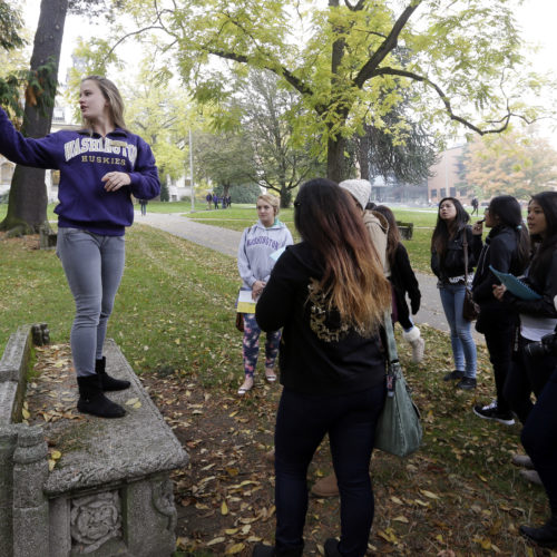 In this 2013 photo, University of Washington sophomore Megan Herndon, of Kailua, Hawaii, stands on a bench as she leads high school students on a tour of the campus in Seattle. CREDIT: ELAINE THOMPSON/AP