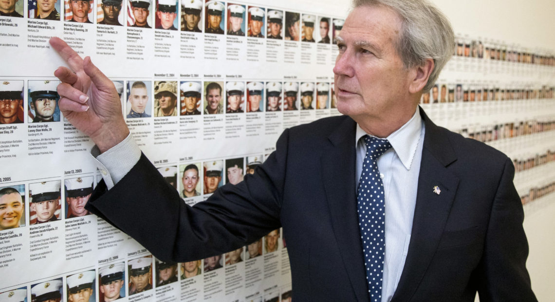 In this file photo, U.S. Rep. Walter Jones, R-N.C., stands in front of photos of fallen soldiers, along a hallway leading to his office on Capitol Hill in Washington. Jones, a once-fervent supporter of the 2003 invasion of Iraq who later became an equally outspoken Republican critic of the war, died Sunday, Feb. 10, 2019. CREDIT: Andrew Harnik/AP
