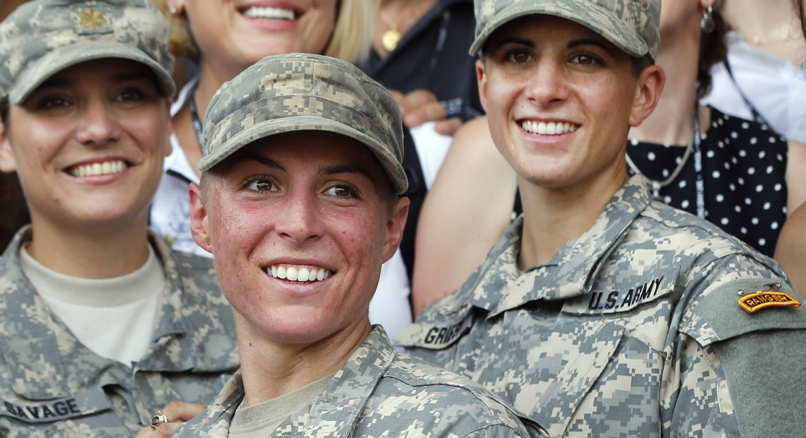 Army 1st Lt. Shaye Haver (center) and Capt. Kristen Griest (right) pose for photos with other female West Point alumni after an Army Ranger school graduation ceremony at Fort Benning, Ga., in 2015. They were the first two women to graduate from U.S. Army Ranger school. CREDIT: John Bazemore/AP