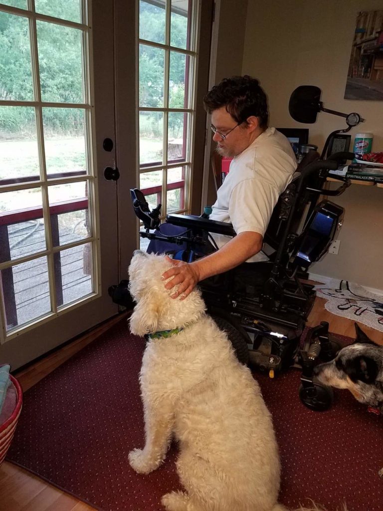 John Combs with his labradoodle, Red. His biggest worry if he loses his Walmart job: "How will I feed Red?" Courtesy of Rachel Wasser