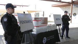 CBP agents, pictured Thursday, stand beside drugs seized last weekend at Arizona's Port of Nogales. CREDIT: U.S. CUSTOMS AND BORDER PROTECTION