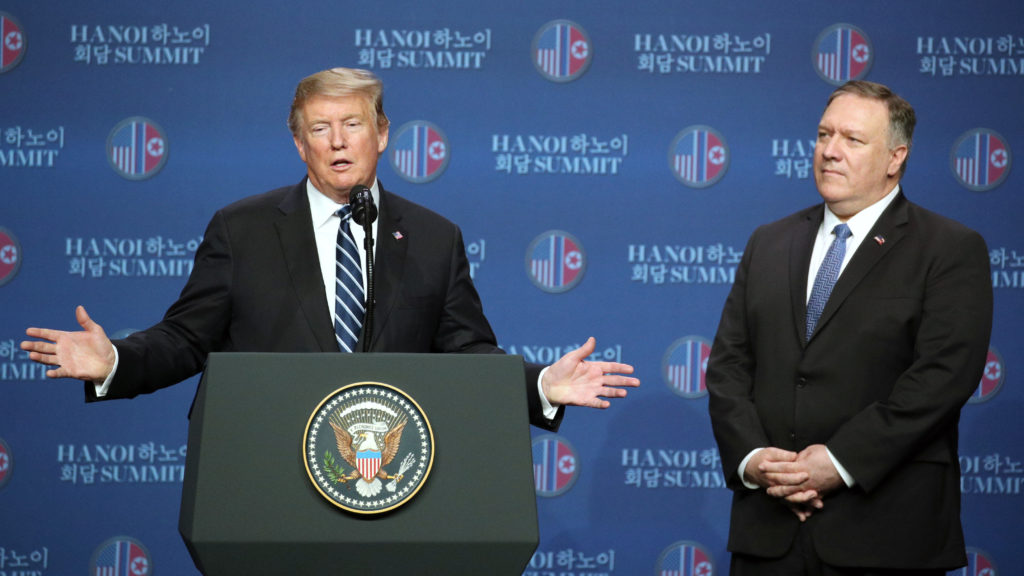 <em>President Trump speaks as Secretary of State Mike Pompeo looks on during a news conference following the DPRK-USA Hanoi Summit in Hanoi. <em>CREDIT: SeongJoon Cho/Bloomberg via Getty Images</em>