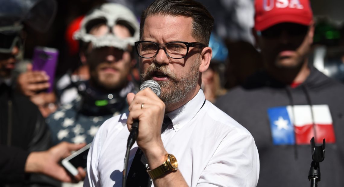 Conservative speaker and Vice Media co-founder Gavin McInnes reads a speech written by conservative commentator Ann Coulter to a crowd during a rally in Berkeley, Calif., in 2017. CREDIT: Josh Edelson/AFP/Getty Images