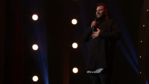Comedian Mo Amer, seen here in his Netflix special The Vagabond, says that stand-up has been a significant part of his "coping process" with an itinerant childhood. CREDIT: Netflix