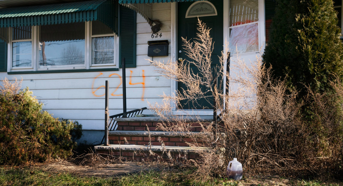 A home in the Lost Valley area of Manville, N.J. The numbers spray-painted on the front of the house indicate that it was bought as part of a federal disaster program. Claire Harbage/NPR