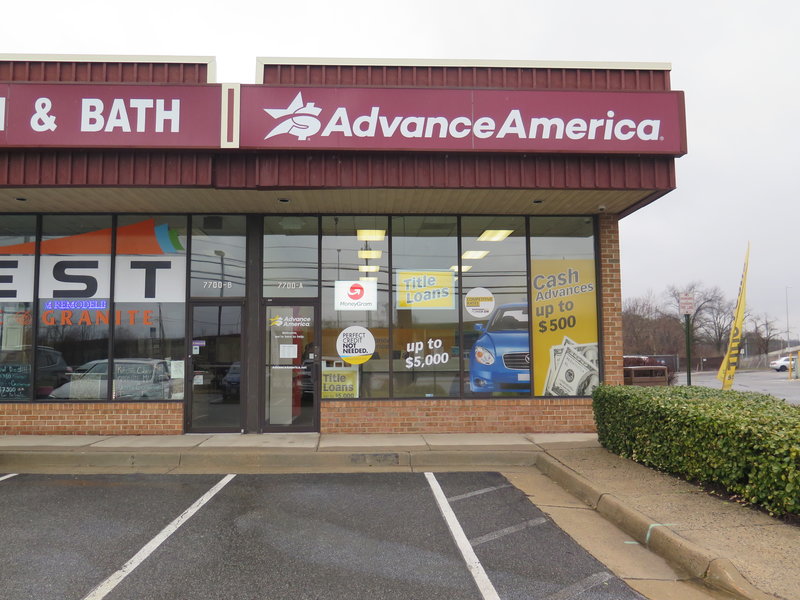 Ads promise cash in the form of payday loans at an Advance America storefront in Springfield, Va. The Consumer Financial Protection Bureau is seeking to rescind a proposed rule to safeguard borrowers from payday lenders. CREDIT: DANIELLA CHESLOW/NPR