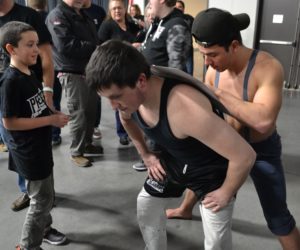 Wrestlers sign autographs. 