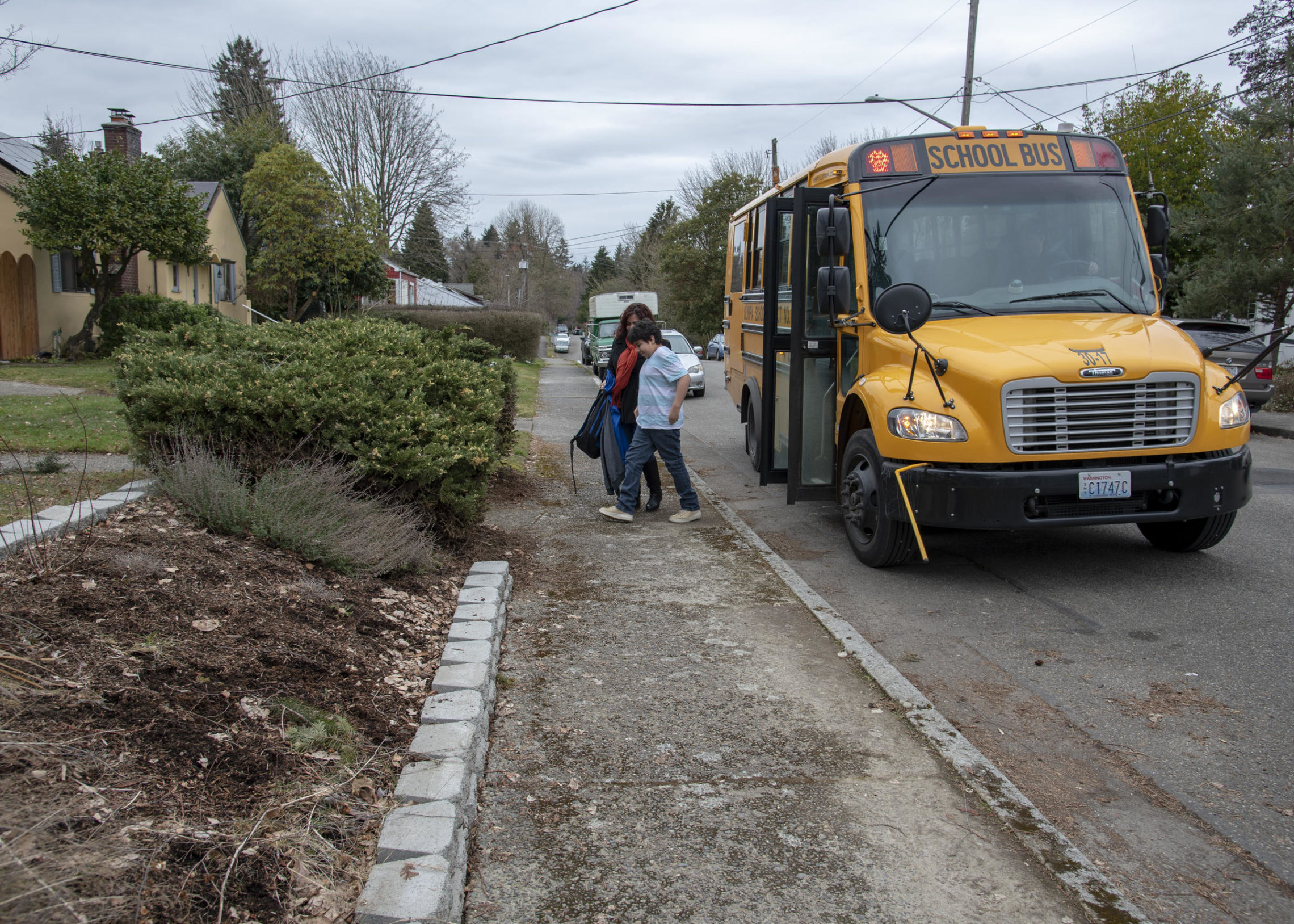 Landa greets Zach outside their home in Olympia as he arrives from school on Wednesday, Feb. 27, 2019. Landa is unable to go to Zach's school because of her felony record, so she must be able to meet him at home when he is finished with school. CREDIT: SHAUNA SOWERSBY / THE TACOMA NEWS TRIBUNE