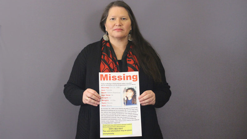 Carolyn DeFord poses with the missing persons poster for her mother, Leona Kinsey, who went missing in October 1999. CREDIT: Dupe Oyebolu/StoryCorps