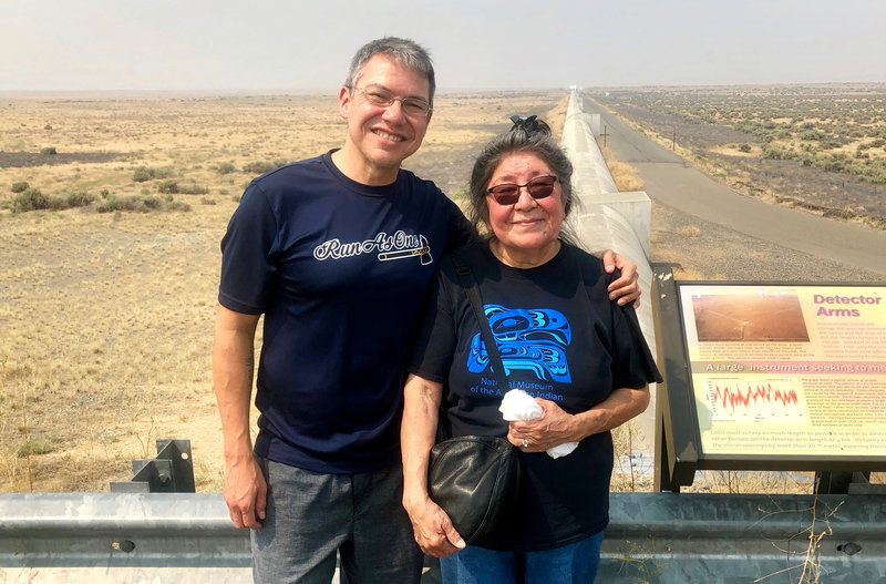 Physicist Corey Gray and his mother, Sharon Yellowfly, are pictured at one of the two massive detectors that make up the Laser Interferometer Gravitational-Wave Observatory. One facility, where Gray works, is in Hanford, Wash., and the other is in Louisiana. Courtesy of Russell Barber