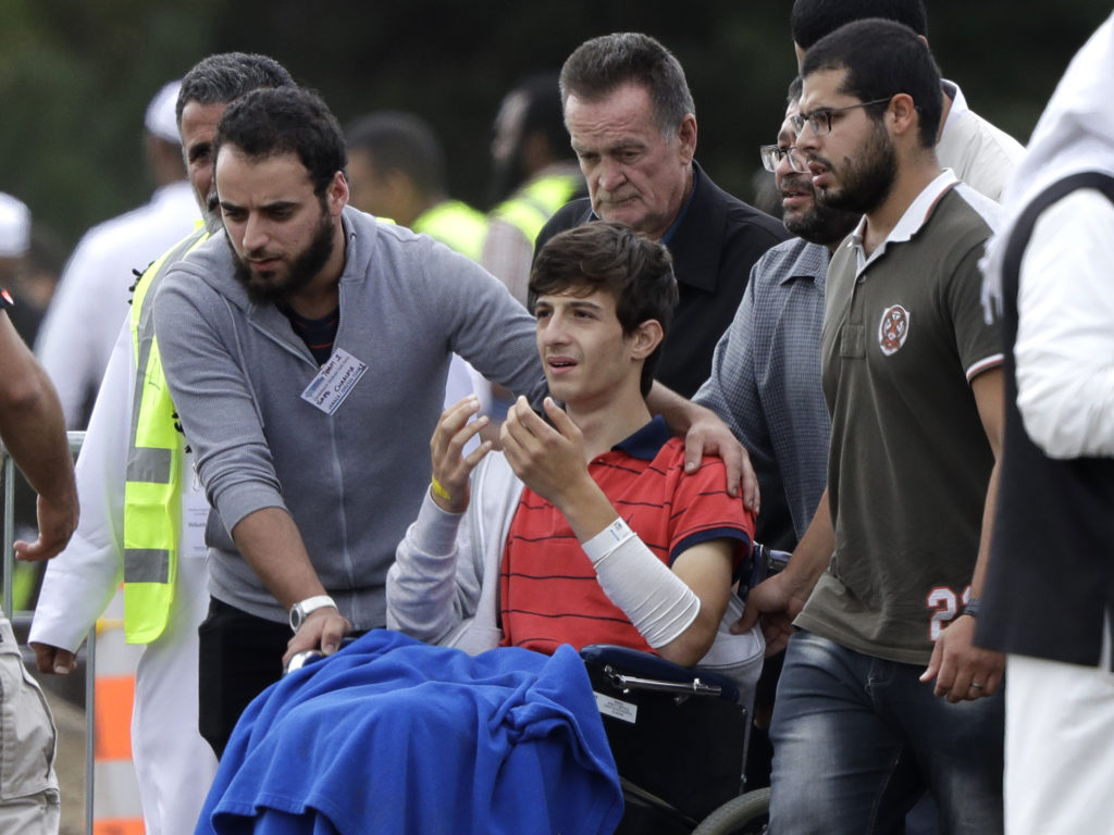 Zaed Mustafa, in a wheelchair after he was injured in the mosque shootings in Christchurch, attends the funeral of his brother, Hamza, and father, Khalid. Mark Baker/AP
