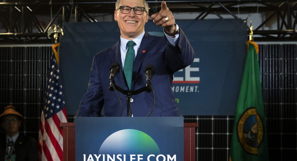 Governor Jay Inslee points to the crowd after announcing his candidacy for President on Friday, March 1, 2019, at A&R Solar on Martin Luther King Jr. Way in Seattle. CREDIT: MEGAN FARMER/KUOW
