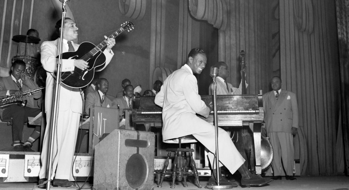 Nat King Cole plays with his jazz orchestra on the stage of The Apollo Theater, in Harlem, N.Y. in the 1950s. Eric Schwab/AFP/Getty Images