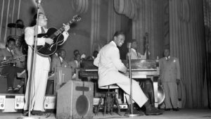 Nat King Cole plays with his jazz orchestra on the stage of The Apollo Theater, in Harlem, N.Y. in the 1950s. Eric Schwab/AFP/Getty Images