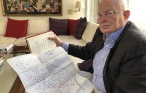 Attorney Emmet Bondurant holds a map of Georgia's congressional districts around the early 1960s, exhibit #9 in the Wesberry v. Sanders case he argued before the Supreme Court as a young lawyer. CREDIT: Johnny Kaufman/WABE