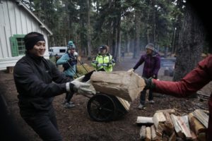 Volunteers help haul wood during the first weekend of each October. CREDIT: IAN MCCLUSKEY/OPB