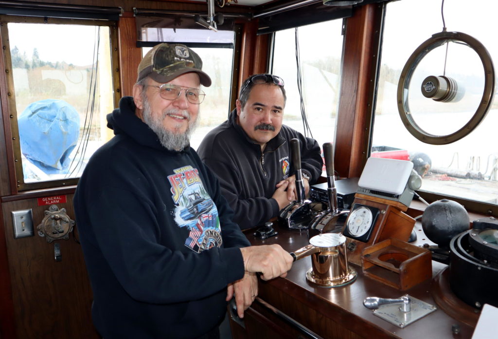 Salvage Chief Foundation chairman Don Floyd (front left) and the ship's owner Floyd Holcom on the bridge. CREDIT TOM BANSE / NW NEWS NETWORK