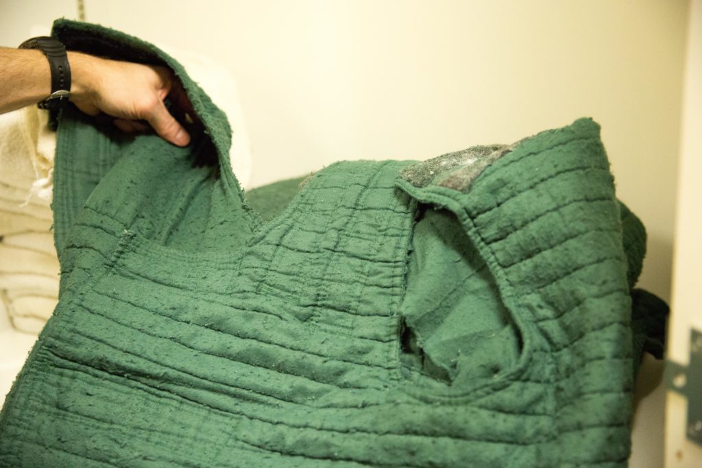 lark County Jail Commander Paul Dougher shows off a suicide smock at the Clark County Jail in Vancouver, Wash., on March 14, 2019. CREDIT: Bryan M. Vance/OPB