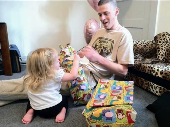 Jeremy Lavender opens gifts with his daughter in an undated photo. Lavender was diagnosed with post-traumatic stress disorder and a traumatic brain injury after serving with the Army in Iraq. His behavior and condition worsened as his relationship with Amy DeHart continued. Courtesy of Amy DeHart.