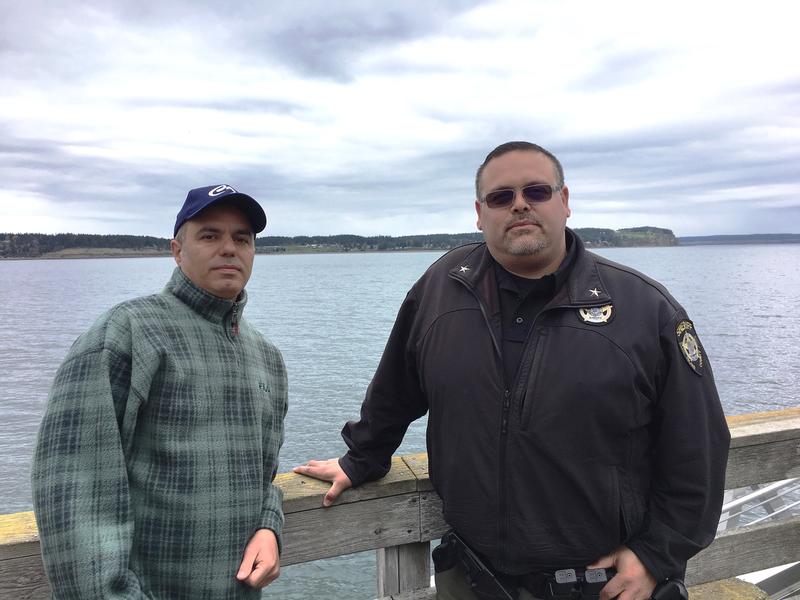 Fred Farris, the father of Keaton Farris, and Island County Jail Chief Jose Briones pose together on the Coupeville Wharf. CREDIT: AUSTIN JENKINS/N3