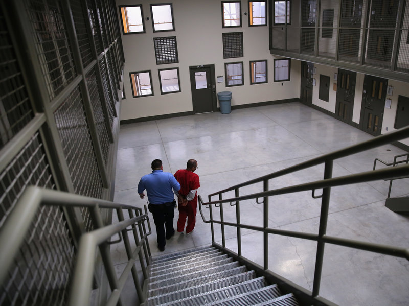 A guard escorts a detained immigrant from his "segregation cell" back into the general population at the Adelanto Detention Facility in November 2013. Today the privately run ICE facility in Adelanto, Calif., houses nearly 2,000 men and women and has come under sharp criticism by the California attorney general and other investigators for health and safety problems. CREDIT: John Moore/Getty Images