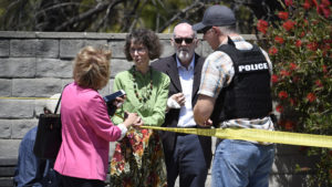 Synagogue members talk to a San Diego County Sheriff's deputy outside of the Chabad of Poway Synagogue on Saturday in Poway, Calif. Denis Poroy/AP