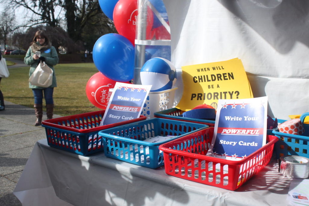 A "When will children be a priority?" flier sits on a table that's part of a march in Olympia calling for more early childhood learning investments in Washington, Thursday, March 14, 2019. CREDIT: MAX WASSERMAN