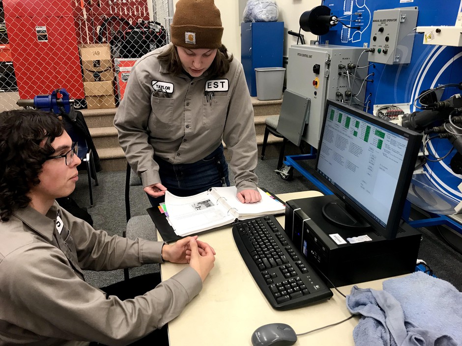 Evan Taylor, left, and Taylor Hays are studying at Walla Walla Community College to work in the renewable energy field. In this class, they’re purposefully causing problems with wind turbine equipment so that they can learn how to fix it. CREDIT: COURTNEY FLATT/NWPB