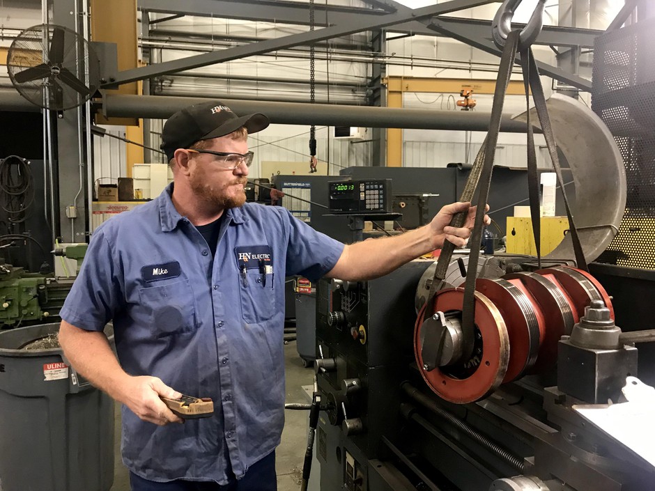 In the mechanical shop at H&N Electric in Pasco, Washington, Mike Byrd works on an essential part of a wind turbine generator. CREDIT: COURTNEY FLATT/NWPB