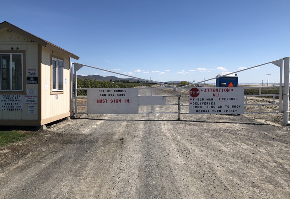 A barricade and a guard shack mark the entrance to King Fuji Ranch outside of the farming town of Mattawa, in central Washington. More than 100 foreign workers have been quarantined for the mumps there. CREDIT: ANNA KING/N3